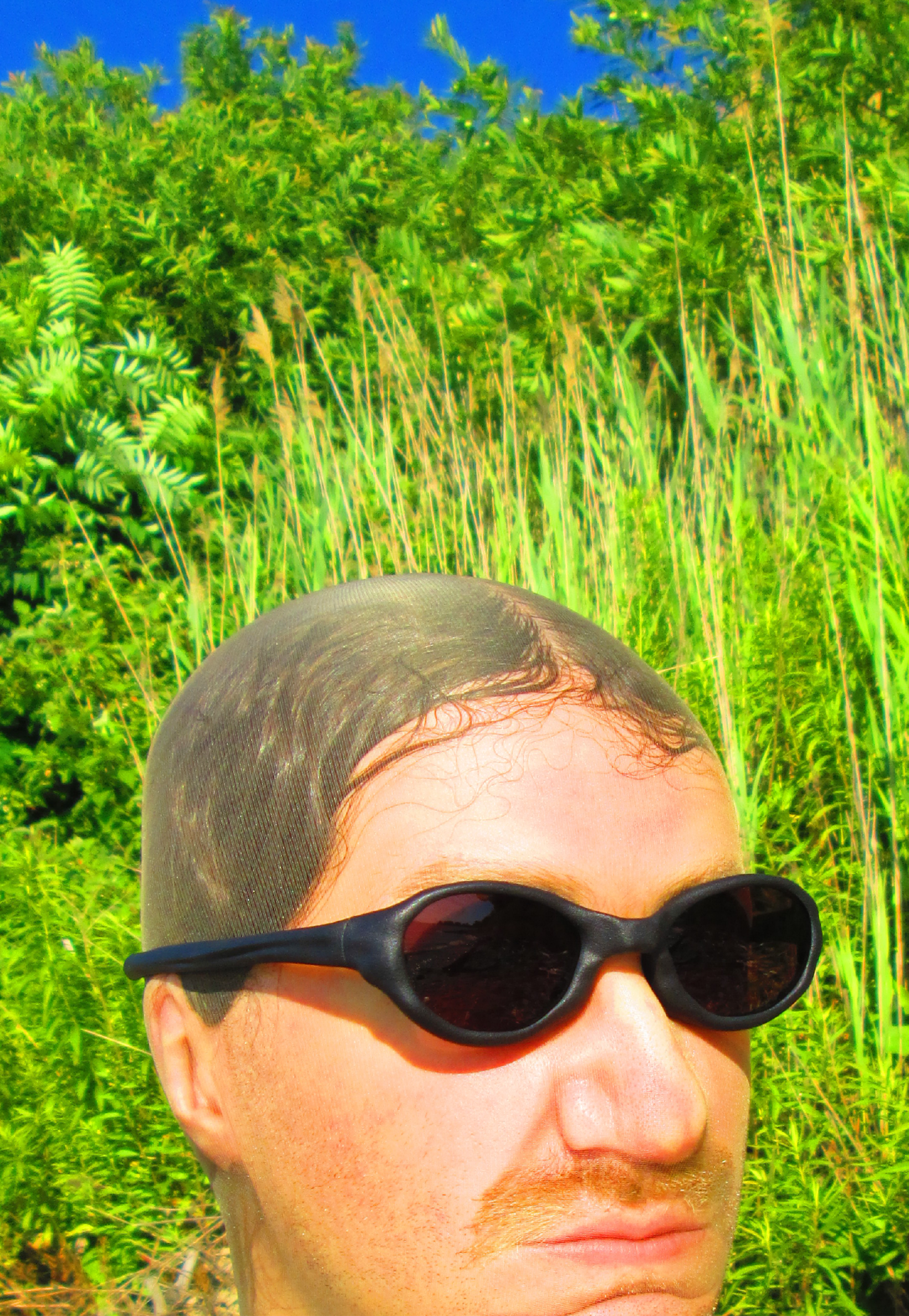 3D render of a bald model wearing black sunglasses with transparent grey lenses